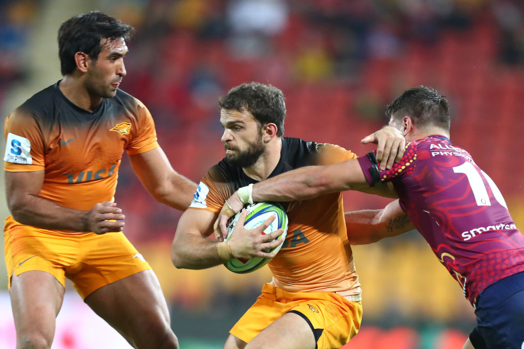 The Jaguares' Ramiro Moyano tries to get away from the Reds defence. Photo: Getty