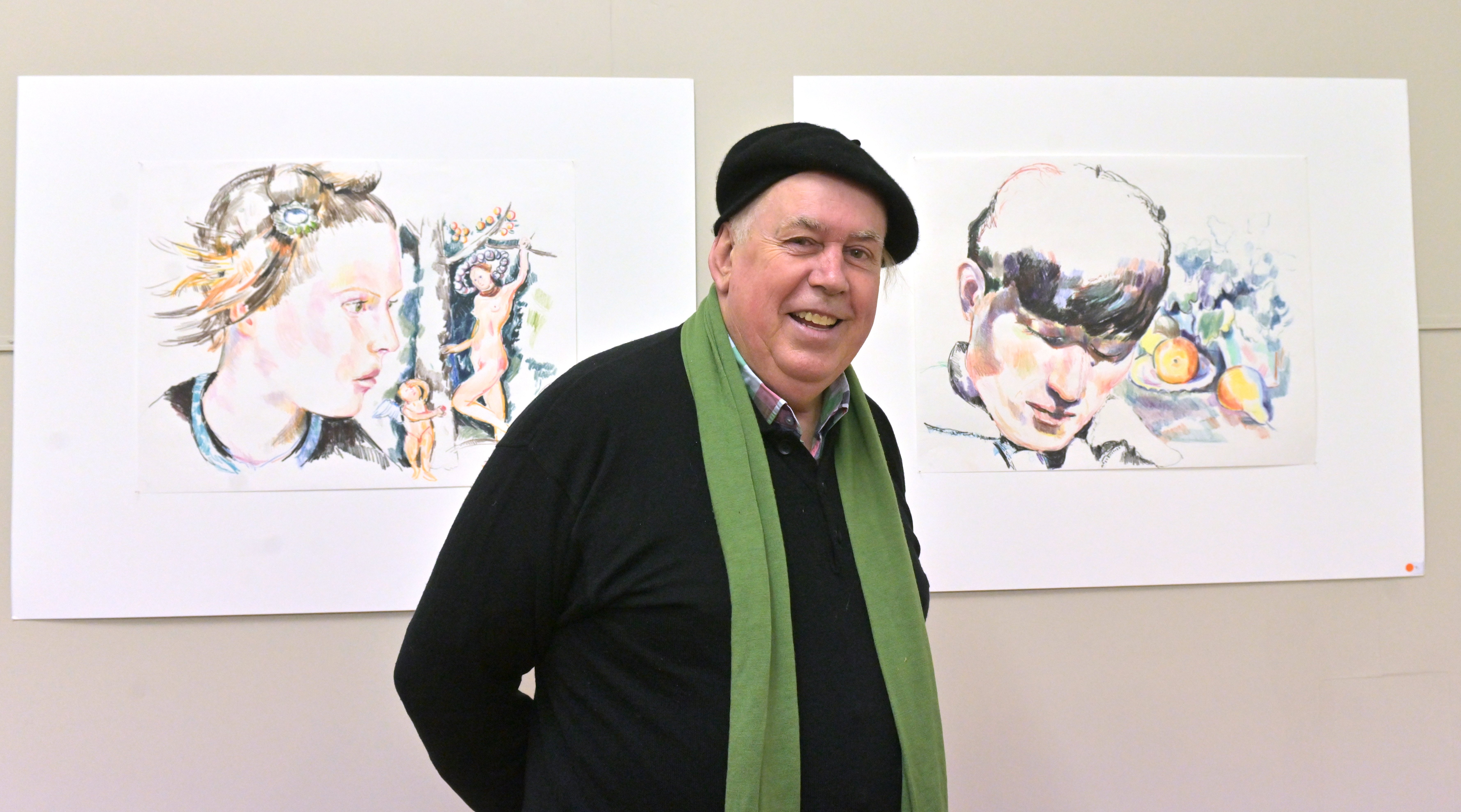 Artist and sexual abuse survivor Michael Haggie shows off two examples of his work at the opening...