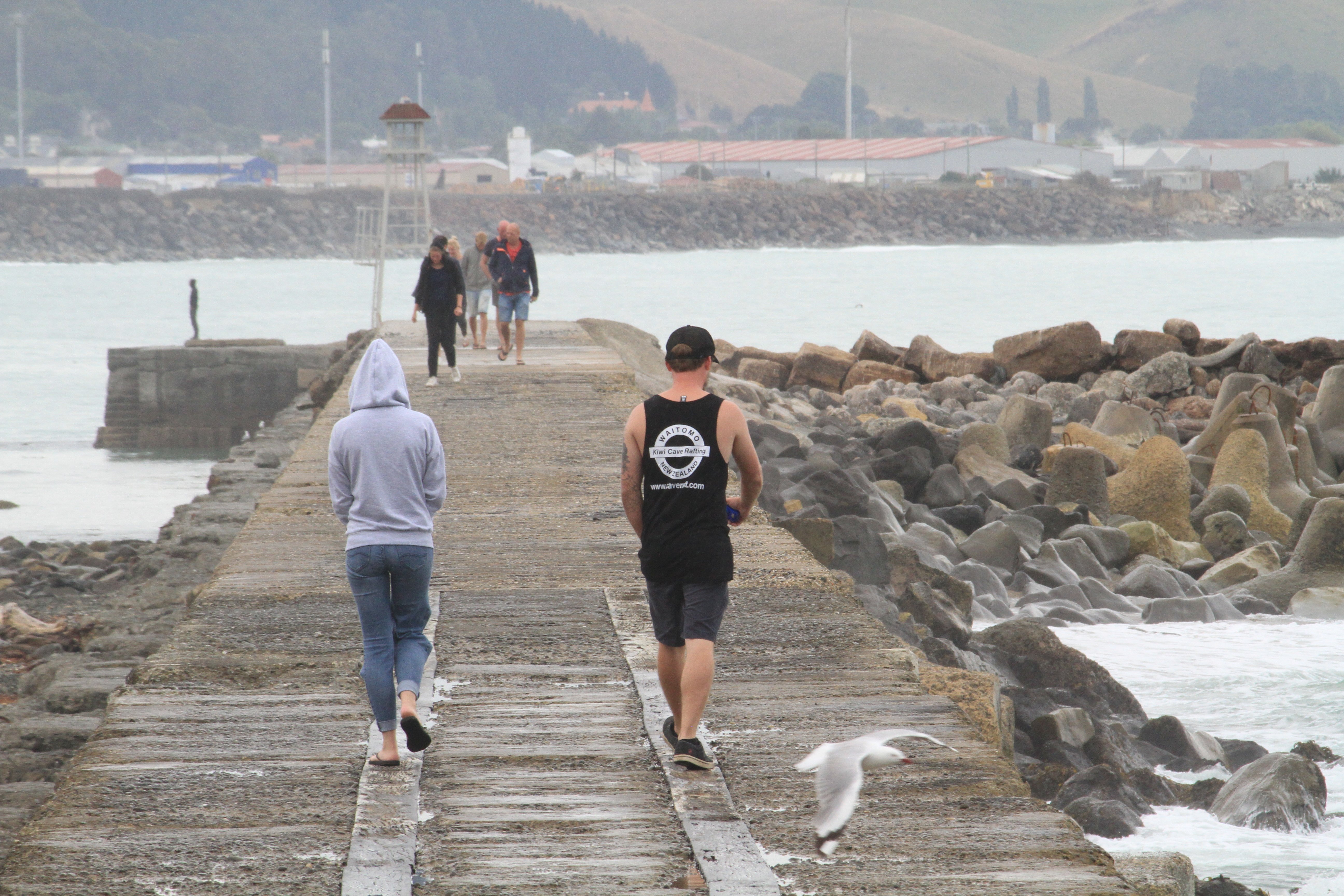 Visitors stroll along Oamaru’s historic breakwater last year. The Waitaki District Council...