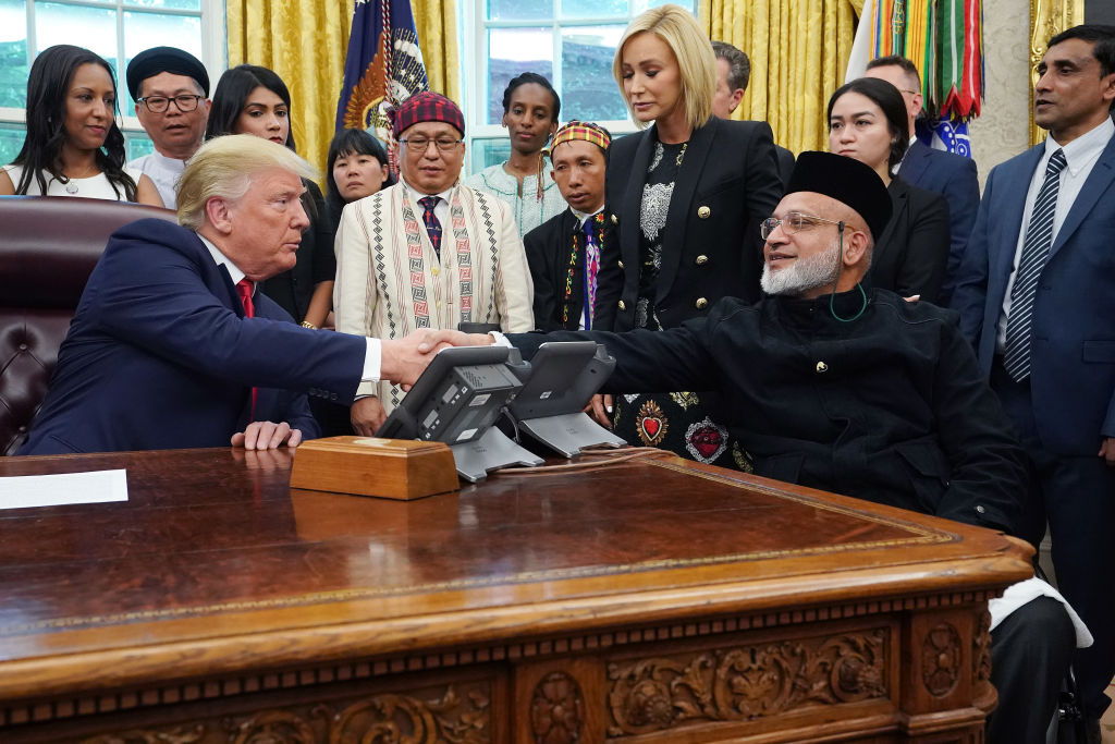 US President Donald Trump shakes hands with Christchurch mosque shooting survivor Farid Ahmed in...