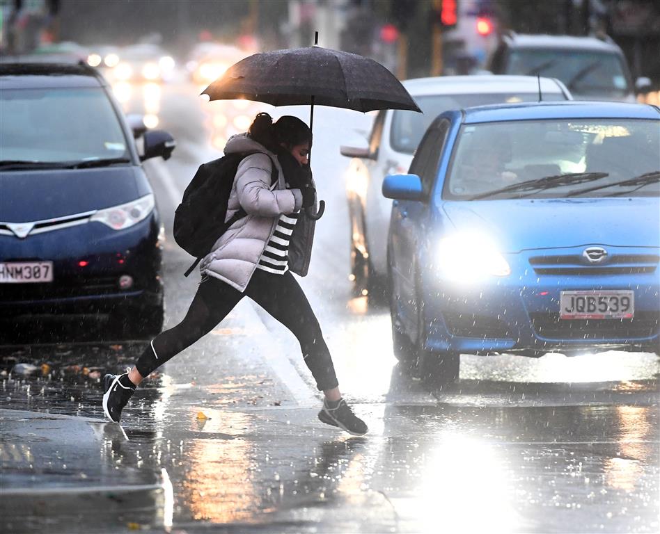 The umbrellas were out for many people in Dunedin this morning. Photo: Stephen Jaquiery