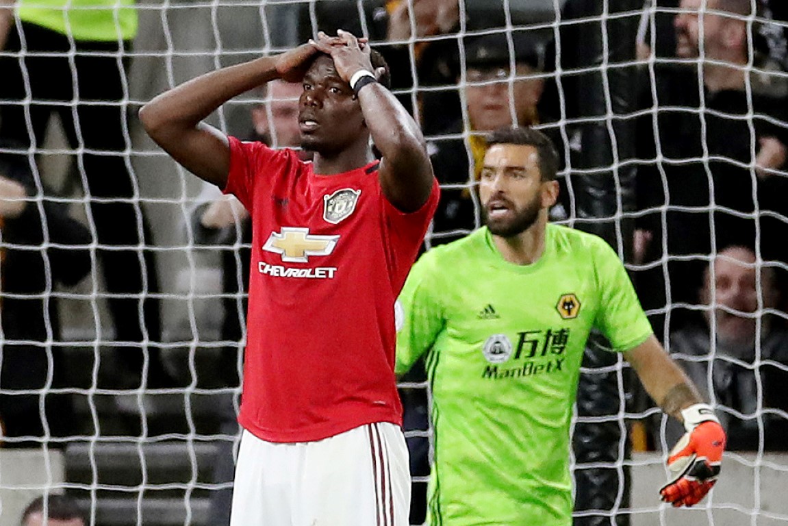 Manchester United's Paul Pogba reacts after his penalty is saved by Wolverhampton Wanderers' Rui...