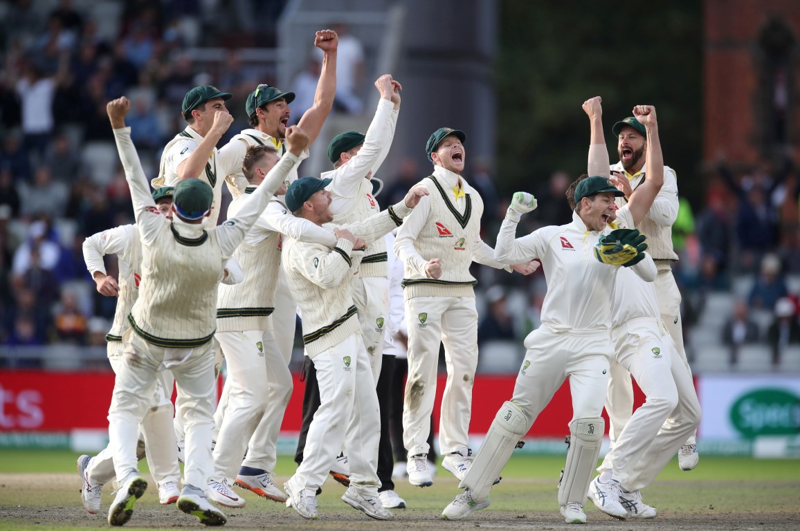Australian players celebrate taking the wicket of England's Craig Overton to win the match and...