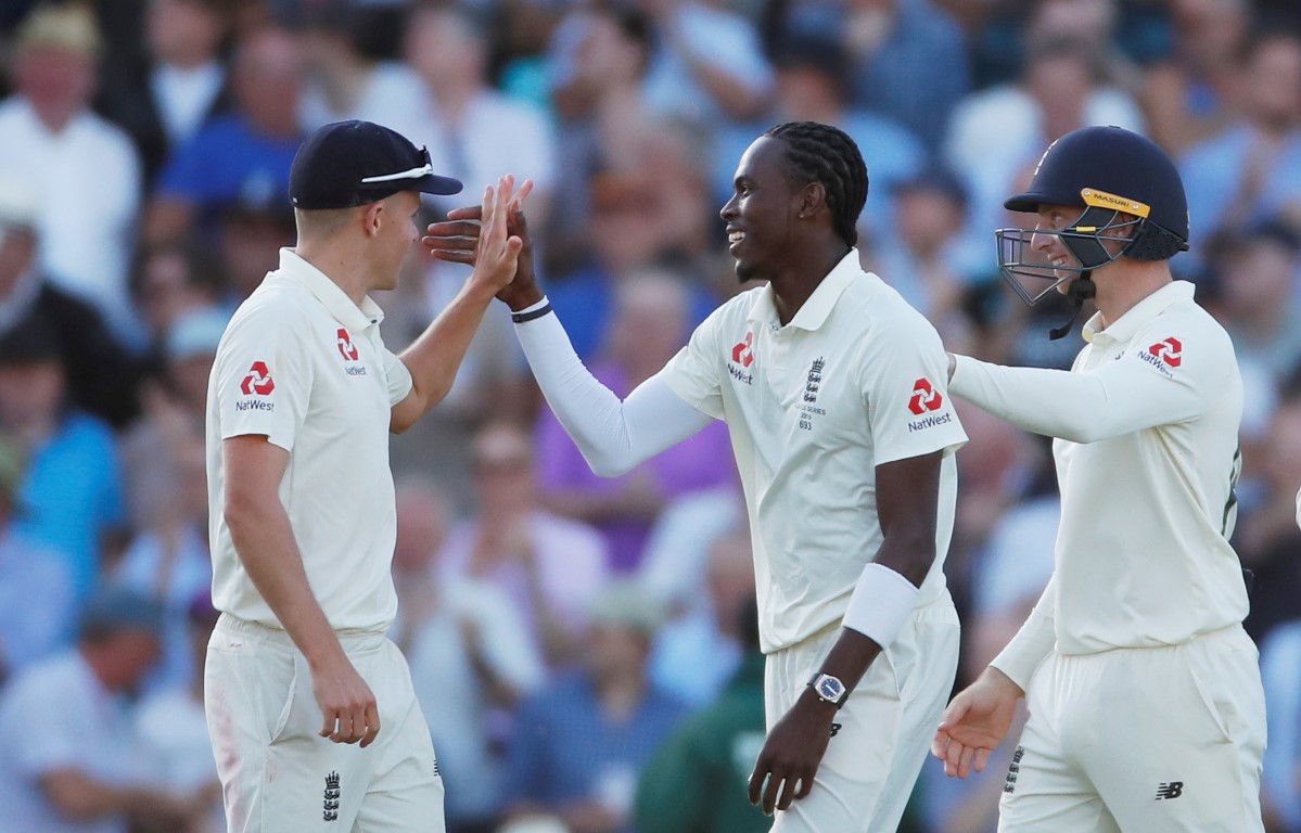 Jofra Archer celebrates with teammates after taking the wicket of Australia's Peter Siddle. Photo...