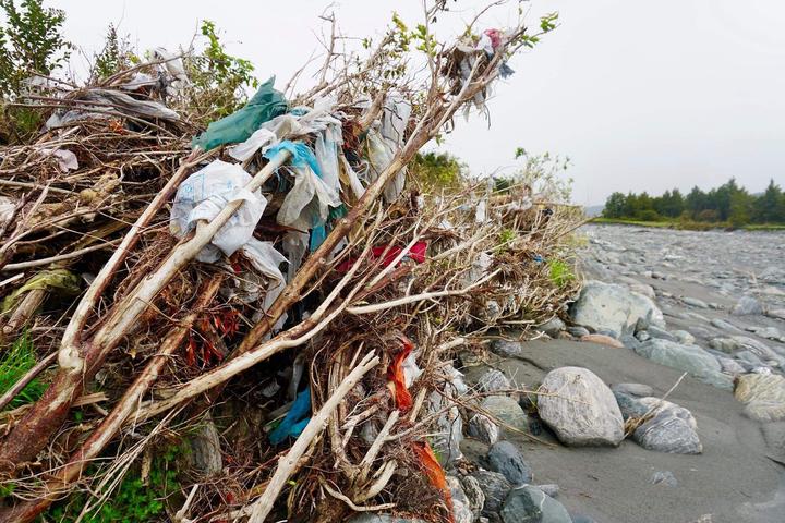 Rubbish trapped on trees and grasses in the Fox River area after the landfill burst. Photo:...