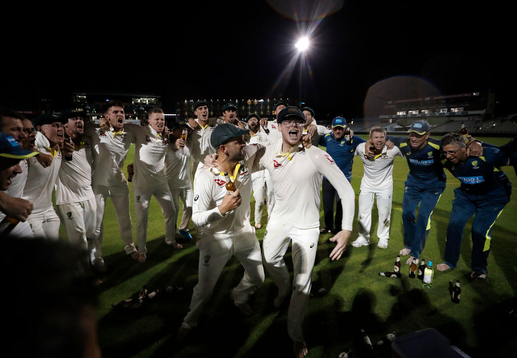 Nathan Lyon and Steve Smith celebrate with teammates after their victory at Old Trafford. Photo:...