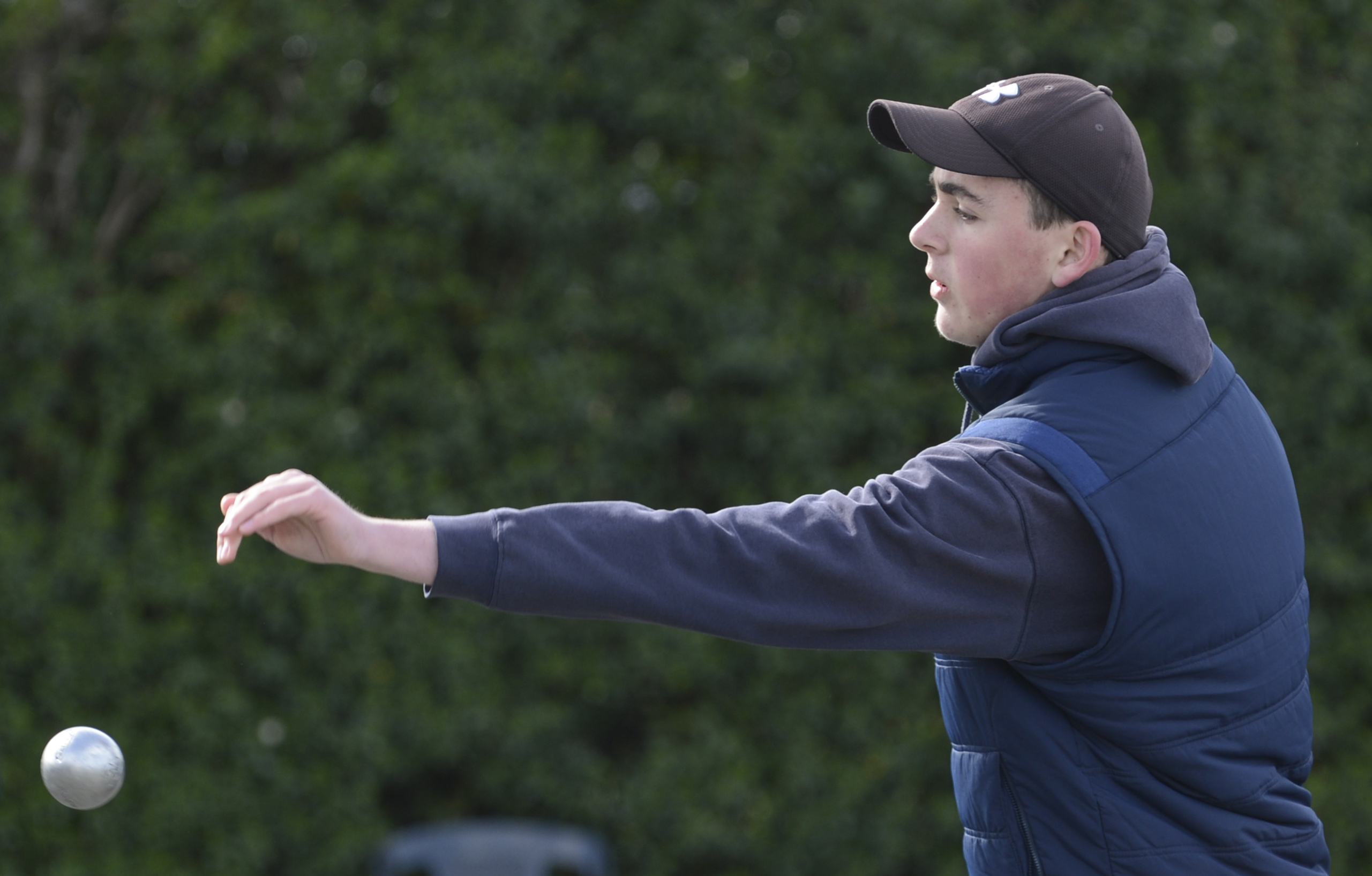 Bayfield High School's Jackson Gallagher (right) competes during the southern region secondary schools petanque tournament at the Dunedin City Petanque club yesterday; (left) several games take place at once. 