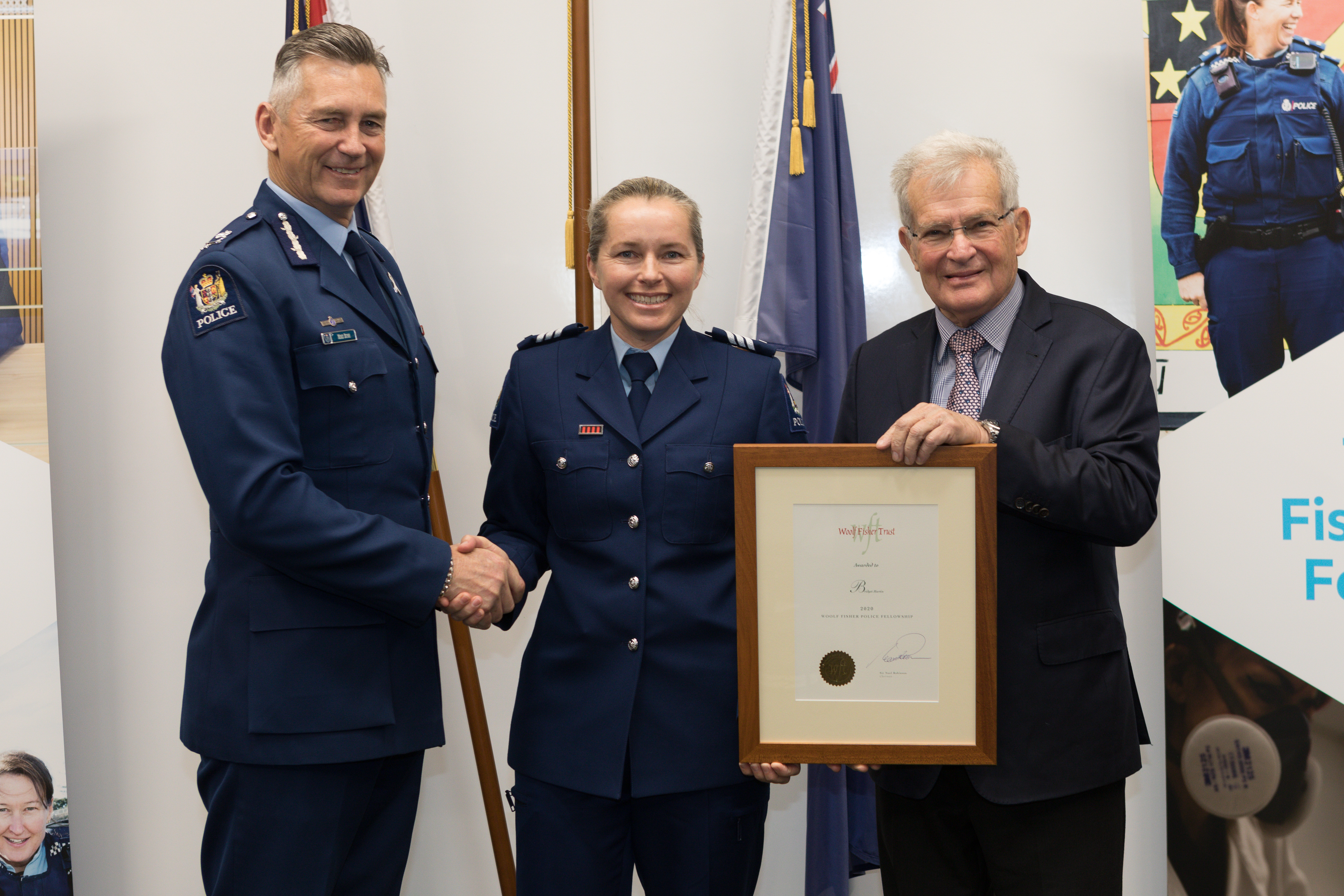 Sergeant Bridget Martin receives her Woolf Fisher Police Fellowship from (left) Commissioner of...