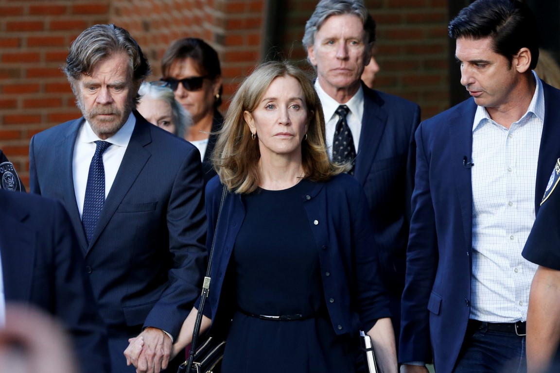 Felicity Huffman leaves the federal courthouse in Boston, Massachusetts with her husband William...