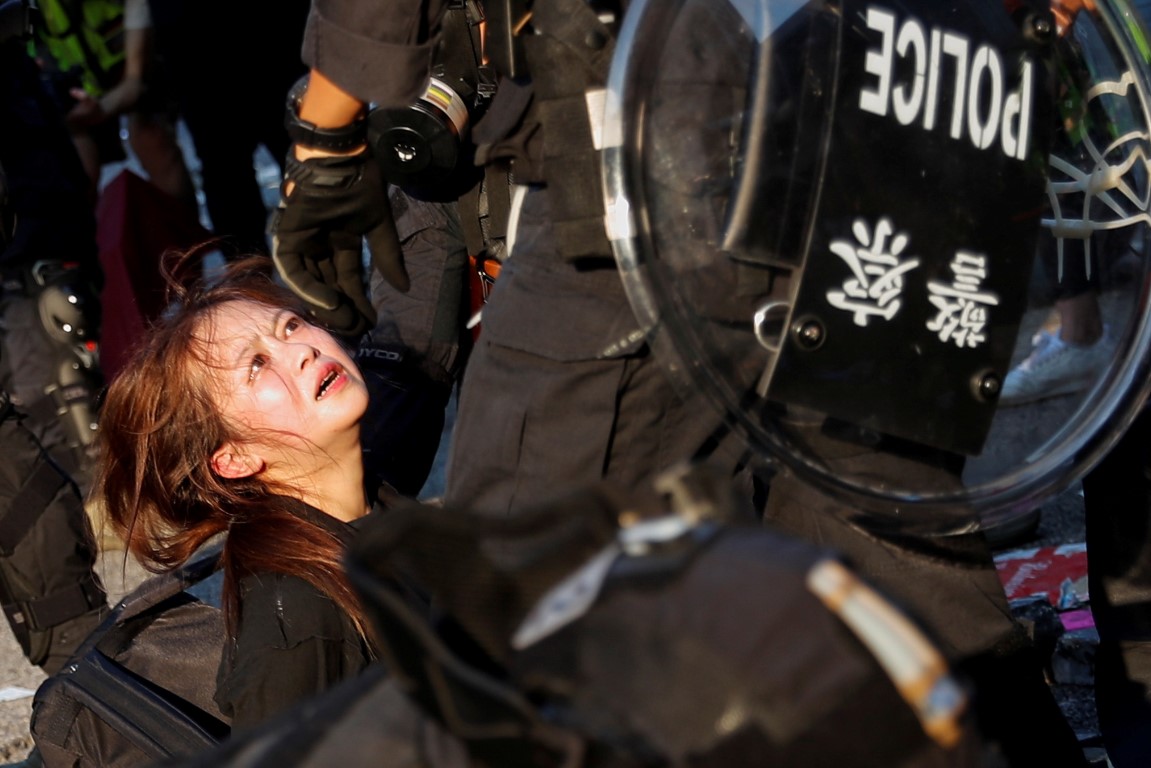 Police detain a protester during a demonstration on China's National Day in Wong Tai Sin, Hong...