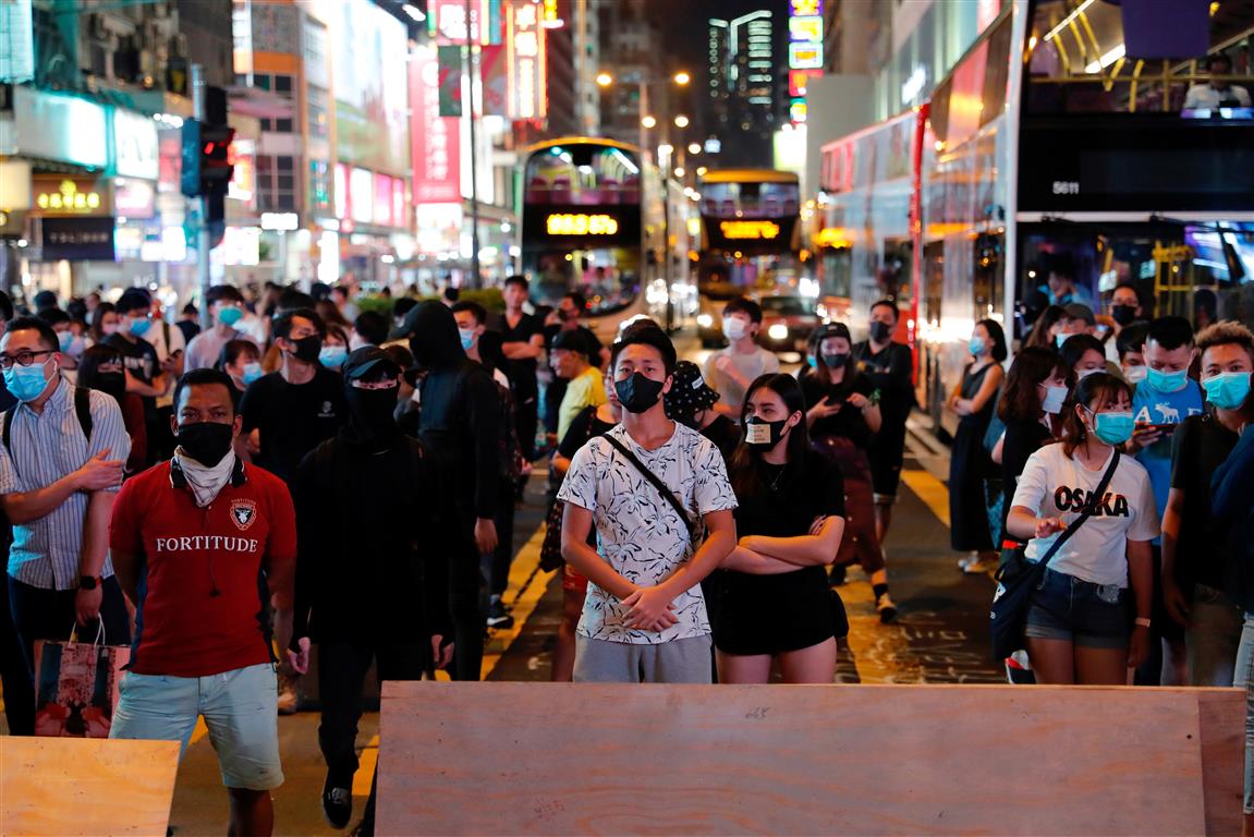 Anti-government protesters wear masks during a demonstration at Mong Kok after the ban on face...