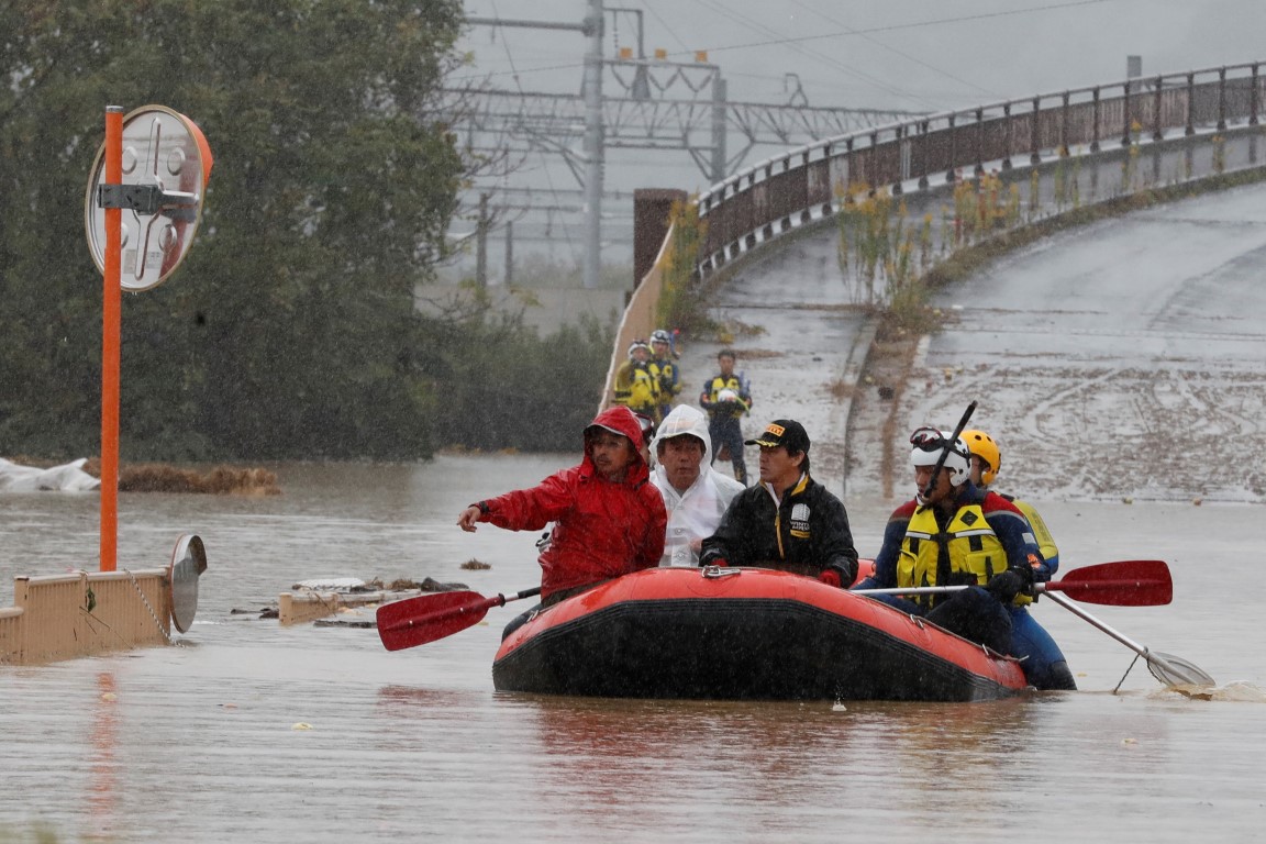 Rescue workers transport a resident in the aftermath of Typhoon Hagibis in Nagano Prefecture....