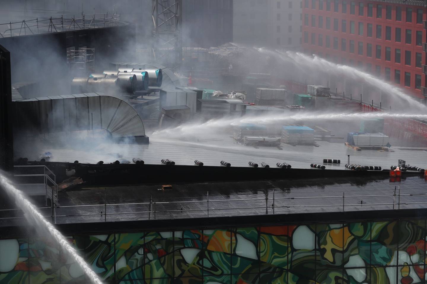 Firefighters are continuing to douse the roof of the Convention Centre. Photo: NZ Herald