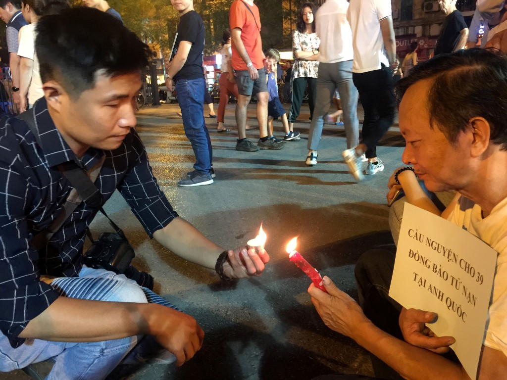 People light candles during a prayer for the 39 victims at Hanoi Cathedral in Vietnam. Photo:...