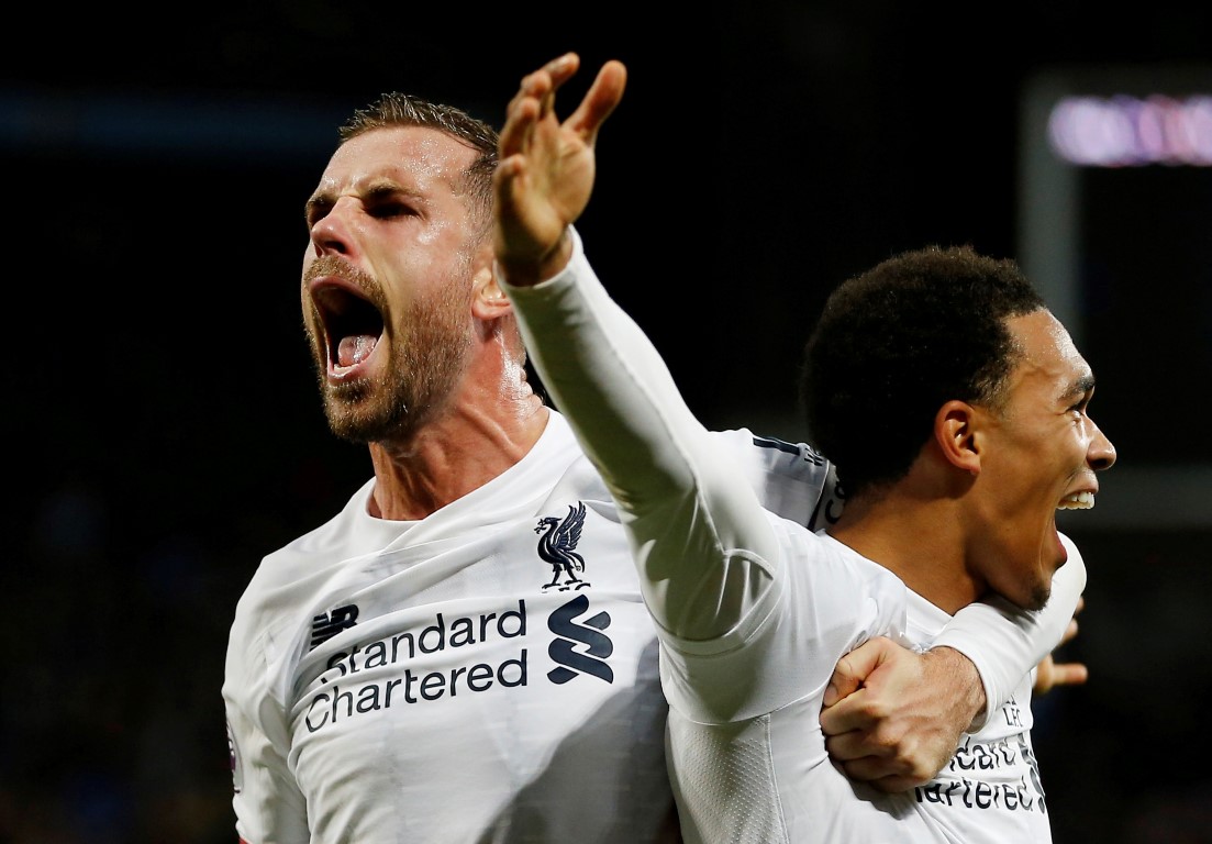 Liverpool's Jordan Henderson (L) and Trent Alexander-Arnold celebrate their second goal scored by...