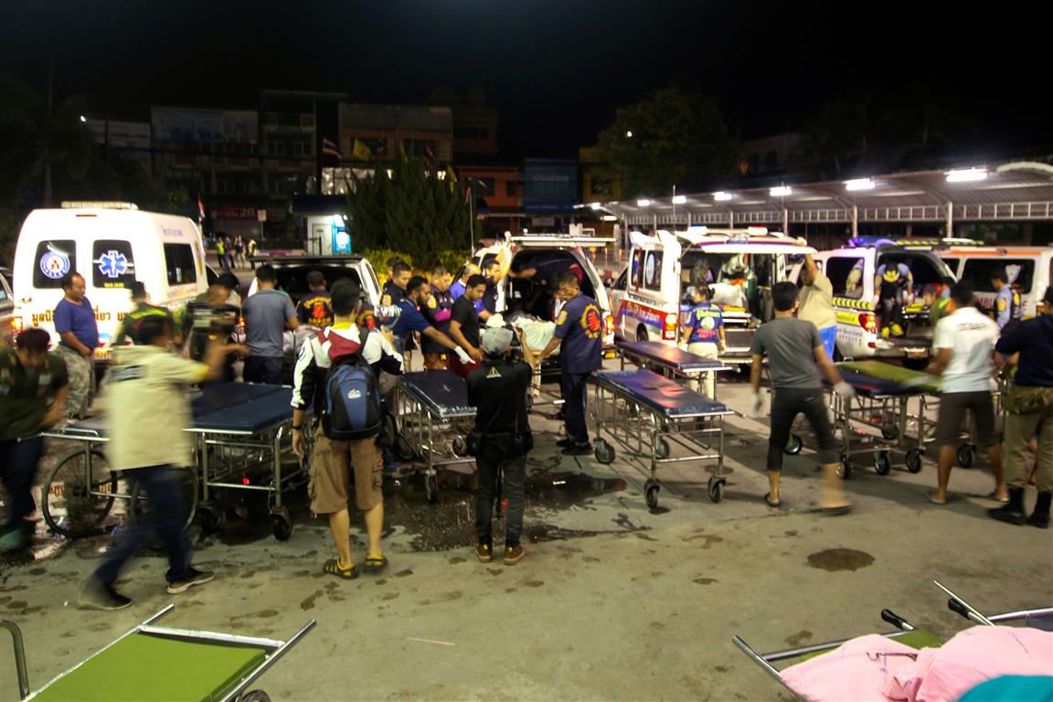 Rescue workers transfer the bodies of victims at a hospital in Yala province, southern Thailand....