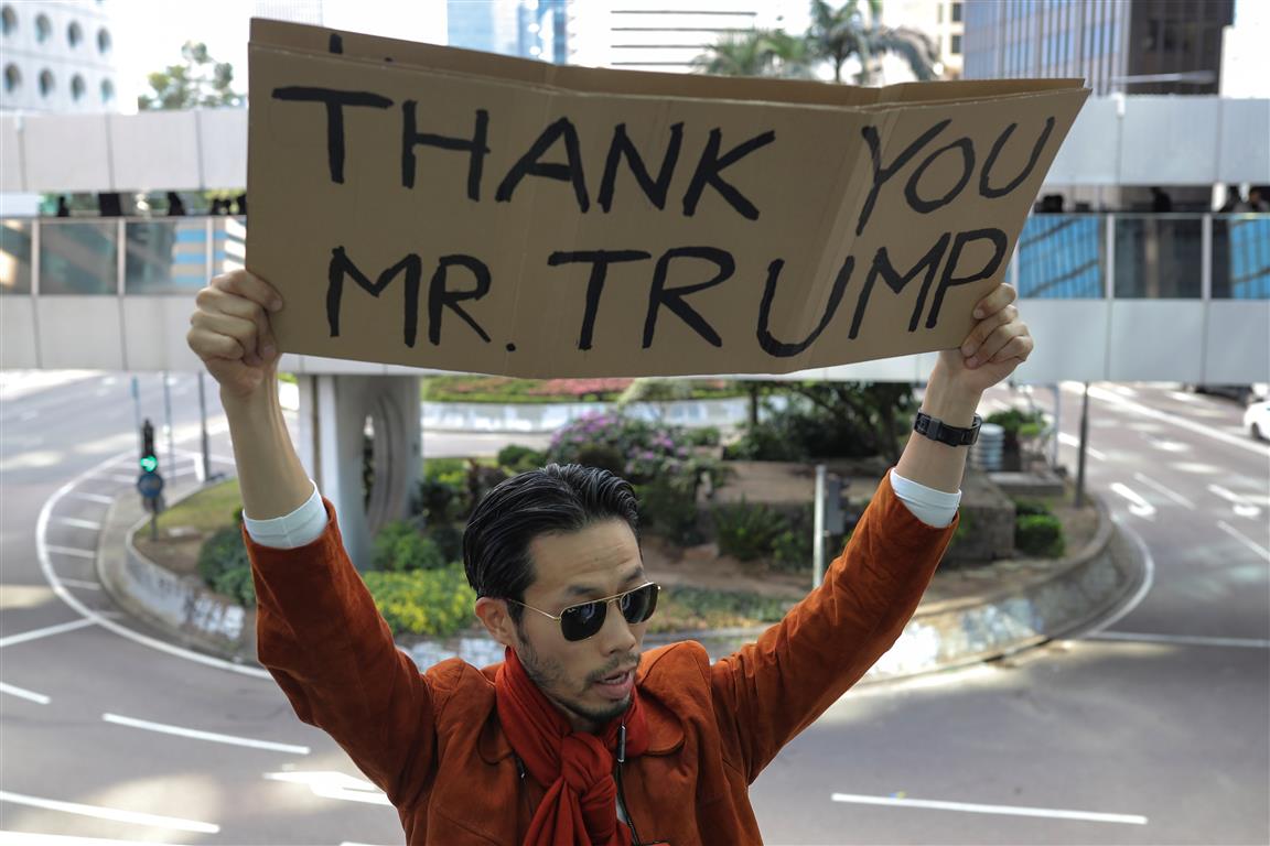 A man holds a placard during a lunchtime protest in Hong Kong on Thursday. Photo: Reuters