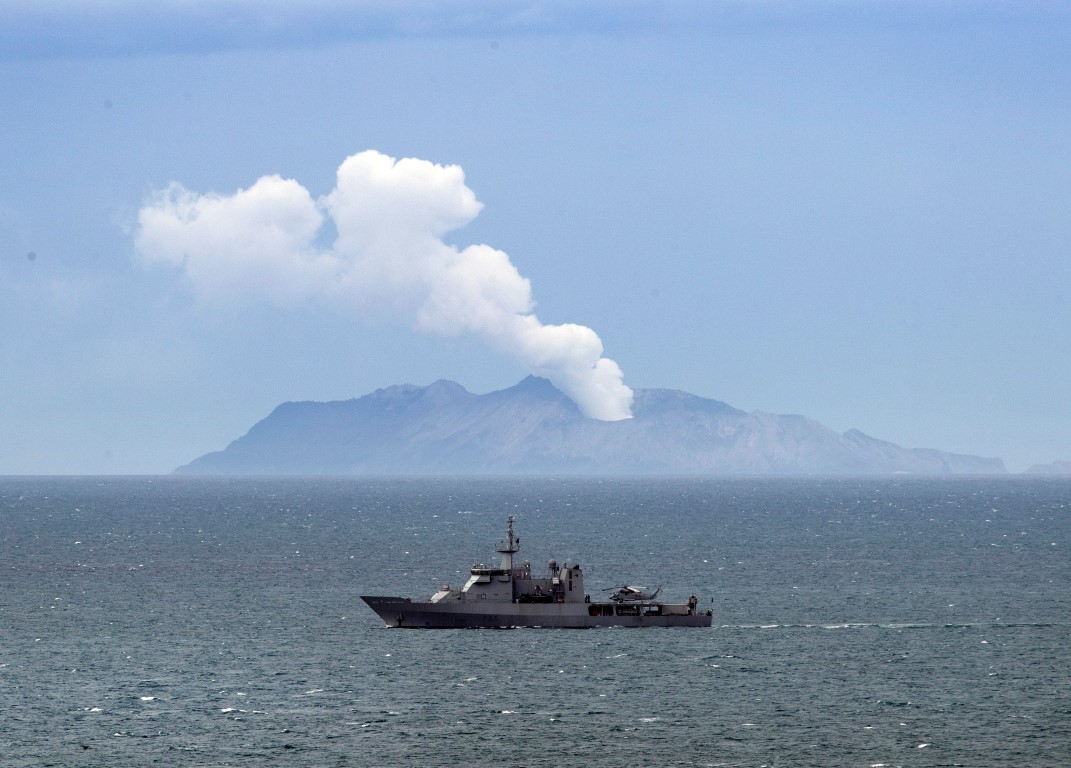 Naval vessel HMNZS Wellington passes White island yesterday as it helps in the recovery mission...