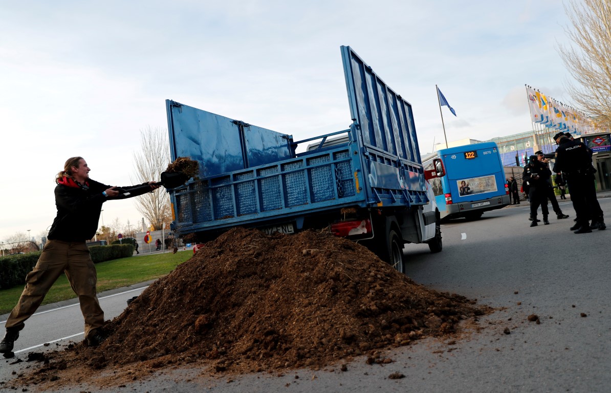 Extinction Rebellion members unload a truck of horse excrement in front of the UN Climate Change...