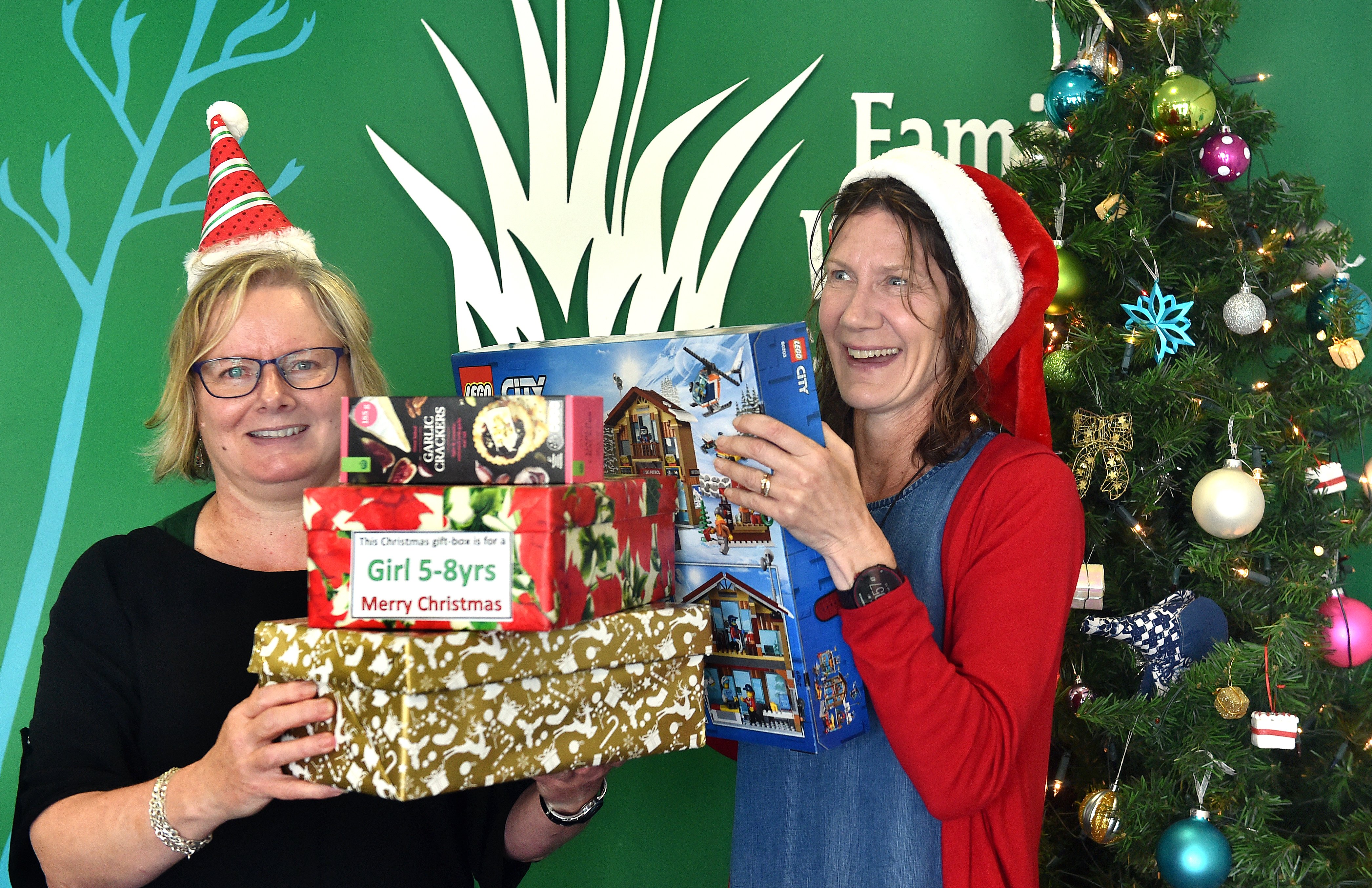 Family Works staff Marie Henderson (left) and Julie Edmunds  celebrate Dunedin’s charitable spirit. Photo: Peter McIntosh