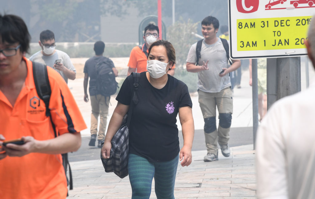 People wear face masks as bushfire smoke haze hangs over Sydney yesterday. Photo: Getty