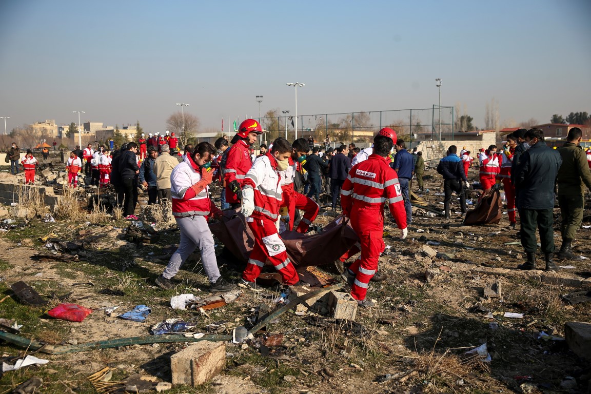 A rescue team at work at the crash site. Photo: Nazanin Tabatabaee/WANA (West Asia News Agency)...