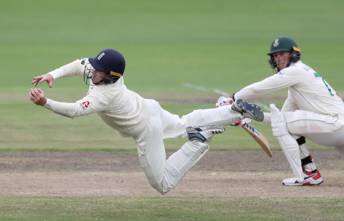 England's Ollie Pope takes a catch to dismiss South Africa's Rassie van der Dussen off the...