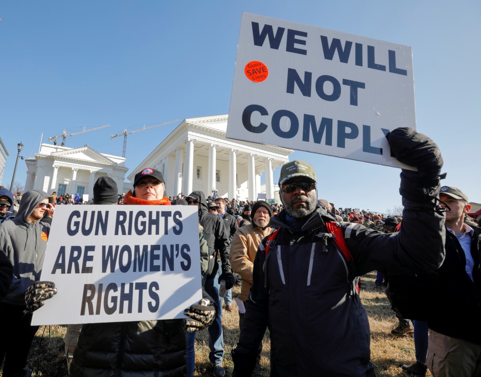 Gun rights advocates attend a rally inside the no-gun zone in front of the Virginia State Capitol...