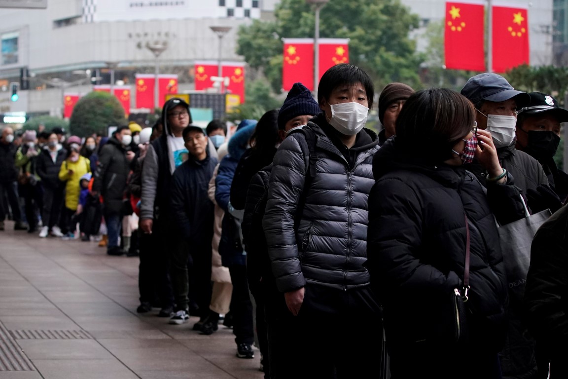 People queue to buy masks at a pharmacy in China. Photo: Reuters