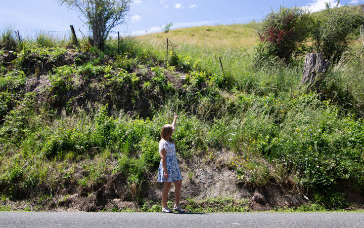 Pamela Coleman at the sight of the accident, pointing up to the area from where the tree stump...