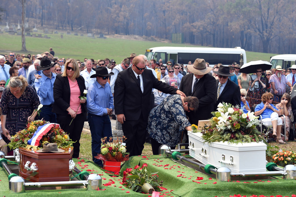 Janelle Salway (R) grieves during the funeral in Cobargo yesterday of her son Patrick and husband...