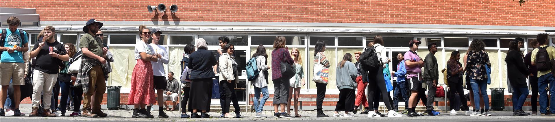 University of Otago students line up for free ice blocks and barbecued sausages during a welcome event at the university summer school. Photos: Peter McIntosh