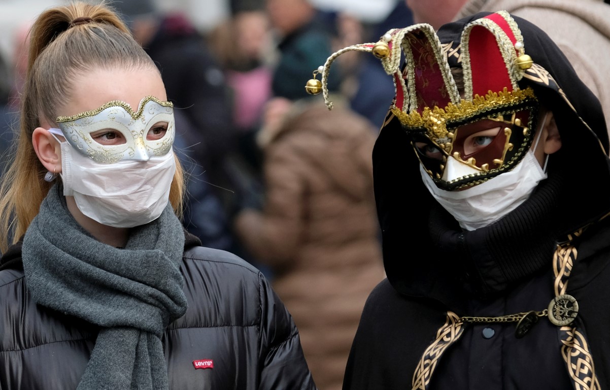 Revellers wear protective face masks at Venice Carnival, the last two days of which have been...