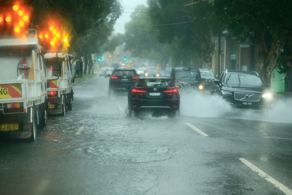 Cars travel through flooded roads in Sydney earlier this week. Photo: Getty Images