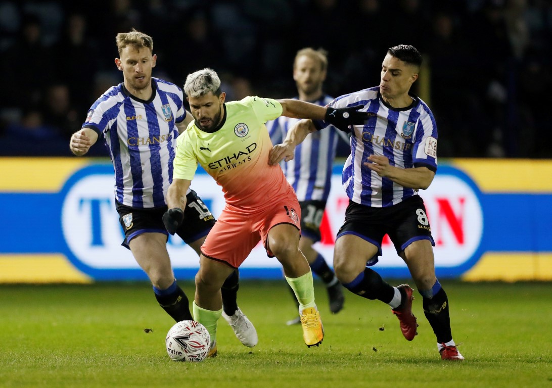 Manchester City's Sergio Aguero in action with Sheffield Wednesday's Tom Lees and Joey Pelupessy....