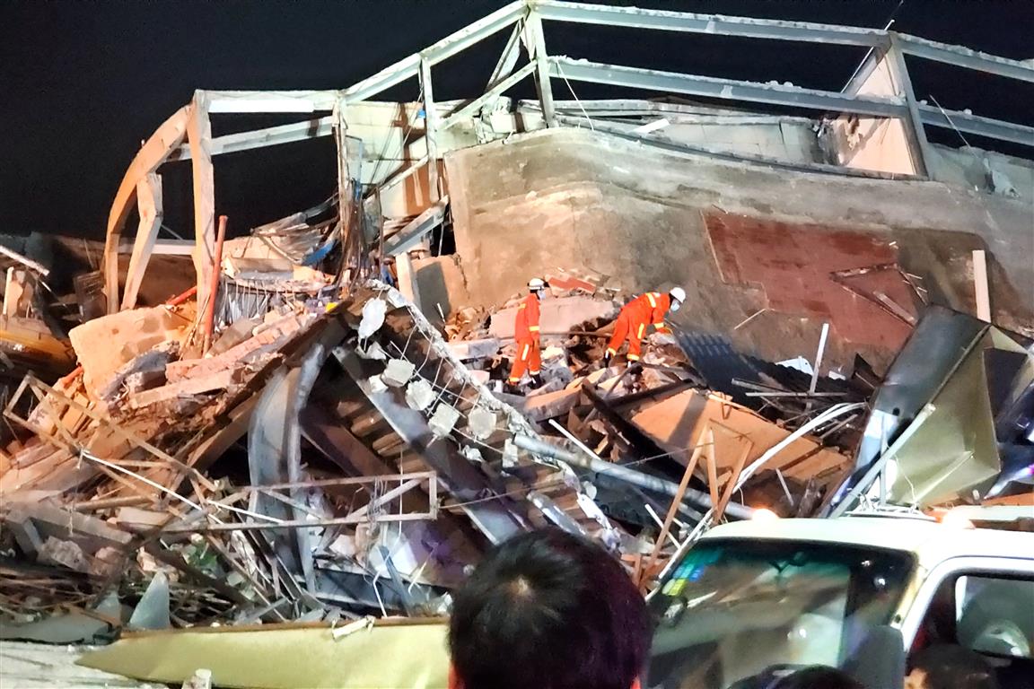 Rescue workers at the scene of the hotel collapse. Photo via Reuters