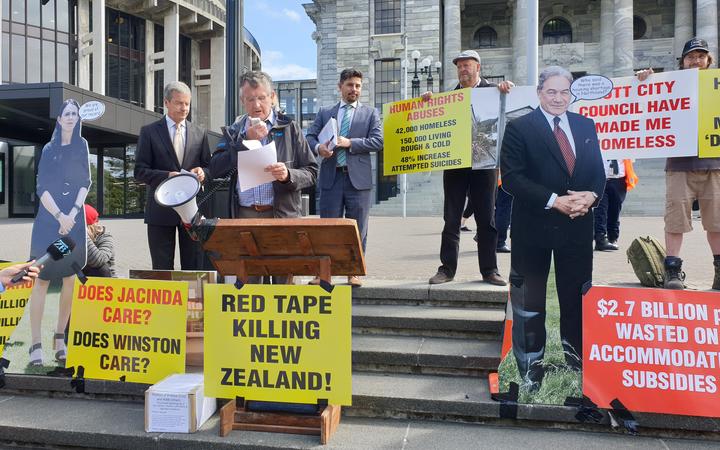 Colin Wightman speaking at the grounds of Parliament at a protest for legislation to protect tiny...