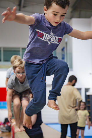 Jack Burns tries out the balance beam.  Photo: Geoff Sloan