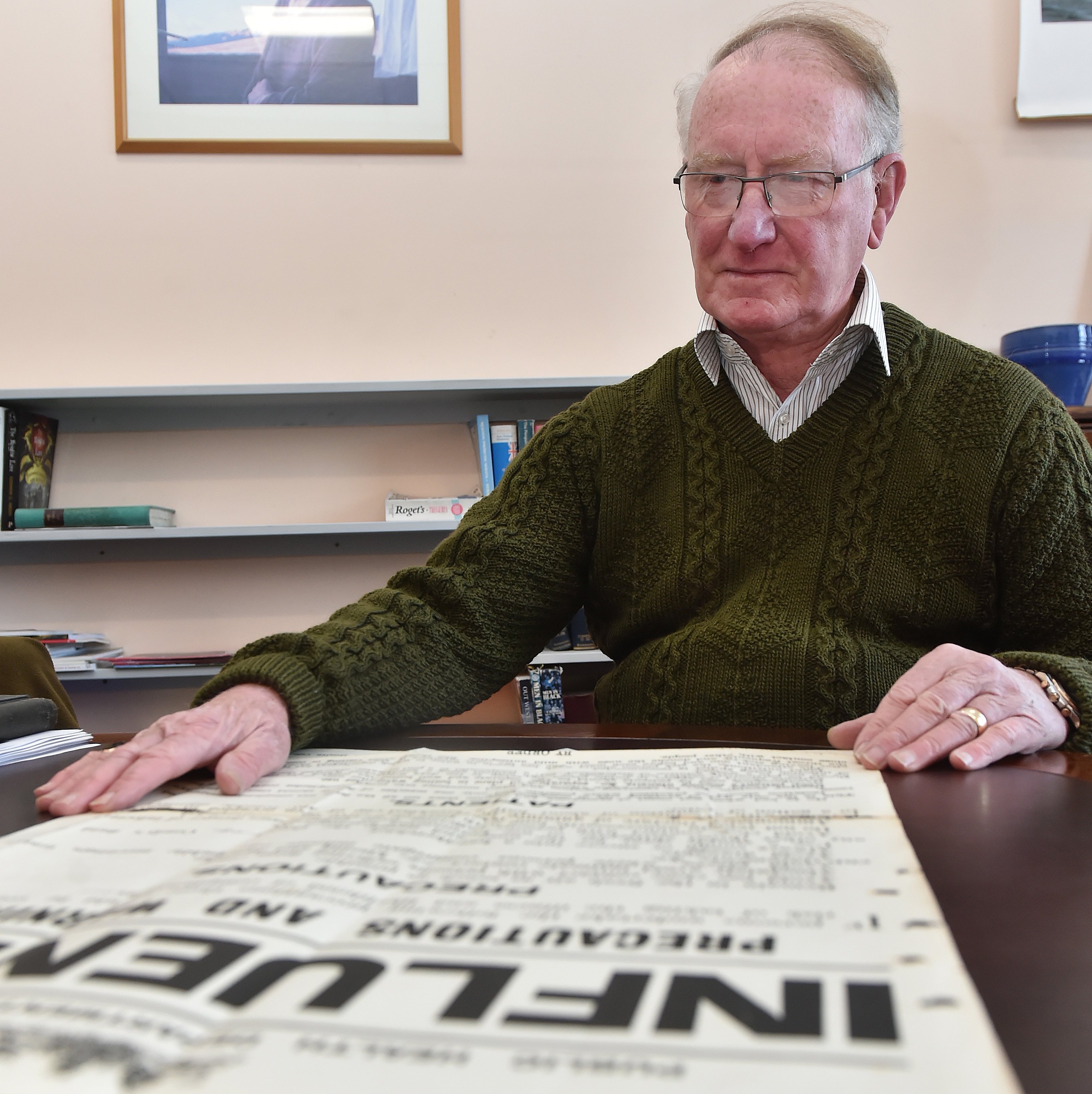 Public health researcher Warwick Brunton with an original public health warning poster produced...