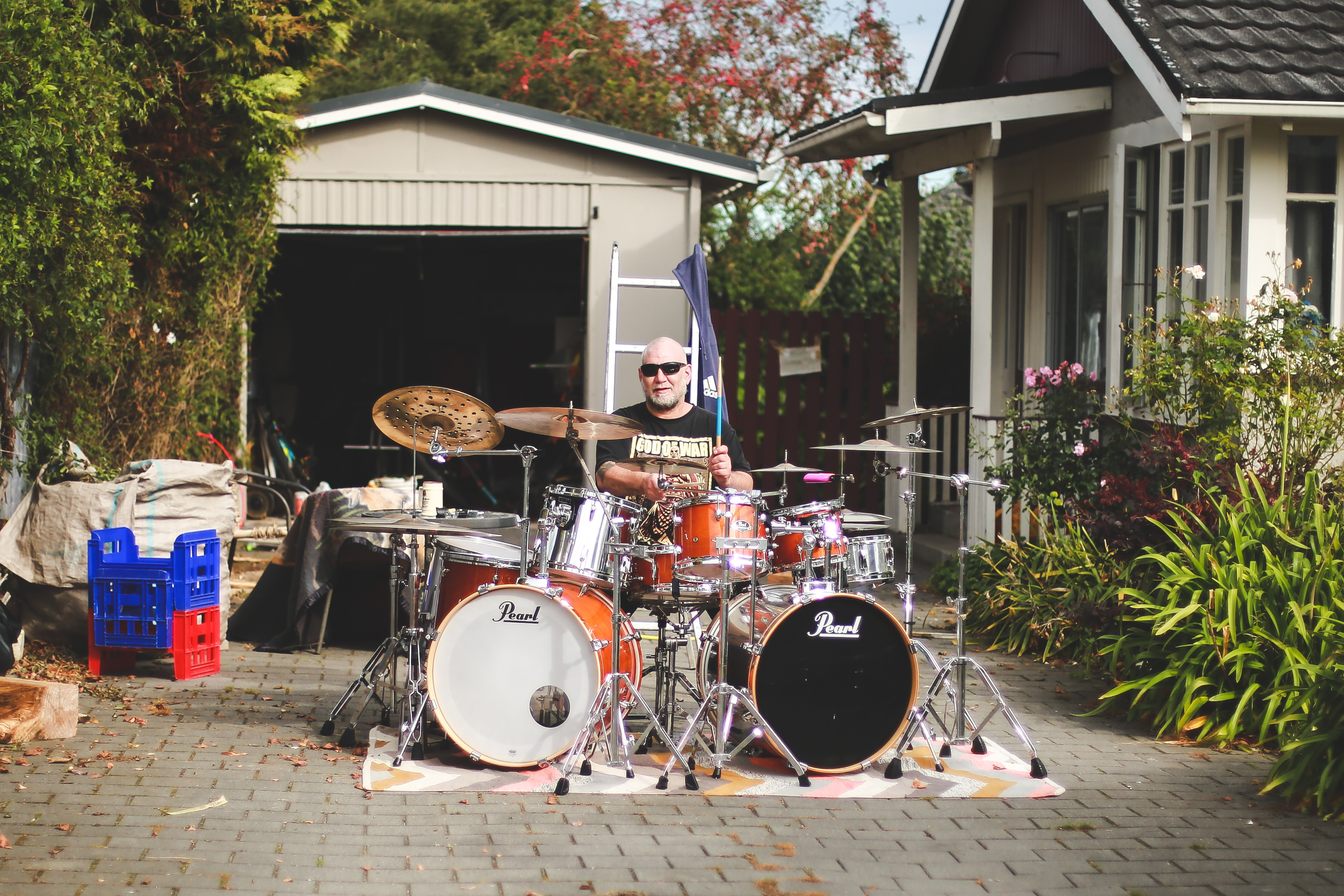 Oamaru musician Tony McDermott on the drums from the comfort of his Arun St driveway