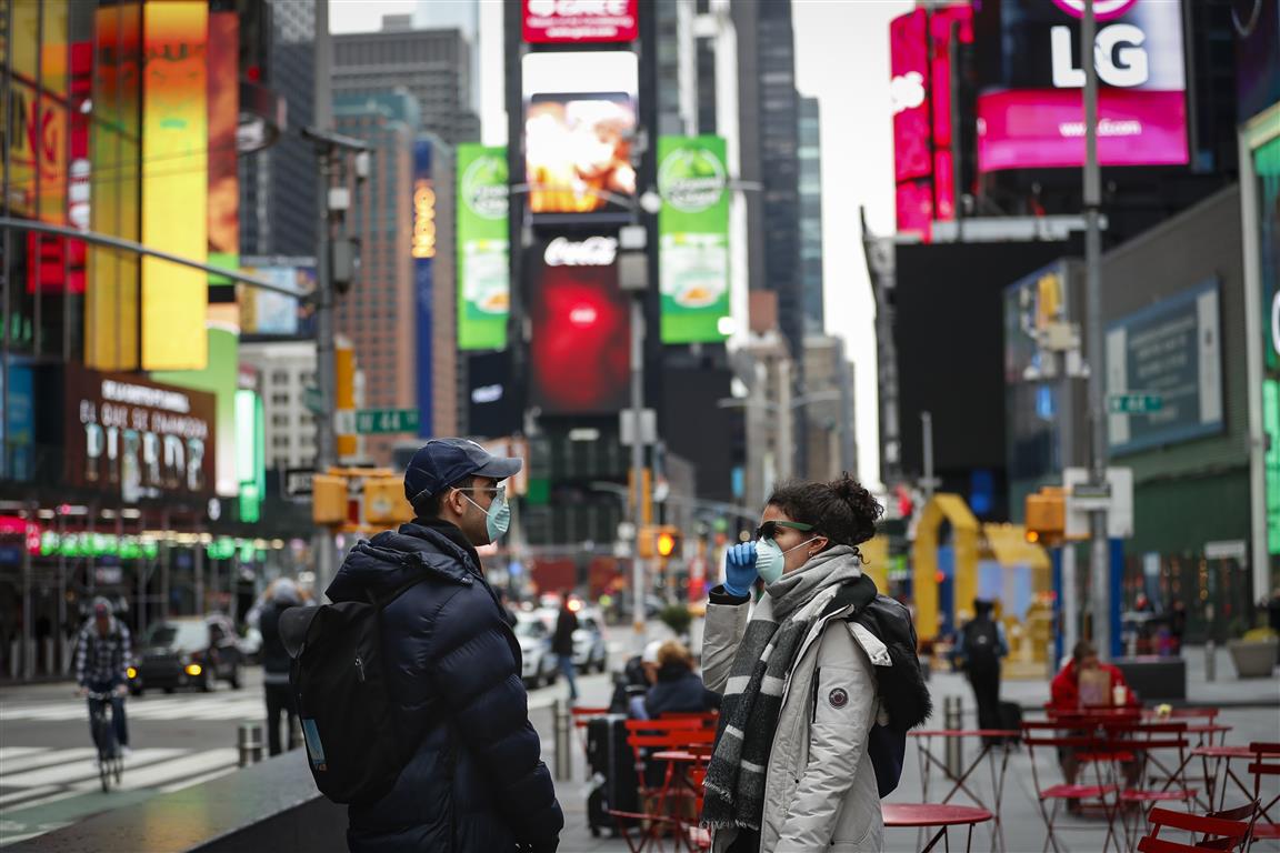 People walk through a nearly empty Times Square in New York City. Photo: Reuters