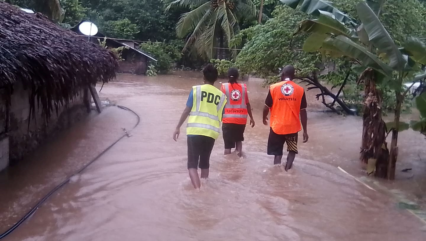 Volunteers walk through floodwaters in Vanuatu in the aftermath of Cyclone Harold. Photo: VANUATU...