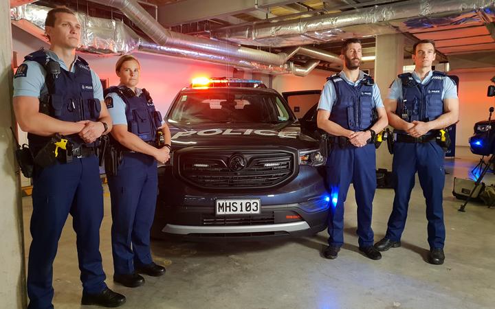 Police officers with one of the armed response team vehicles. Photo: RNZ / Liu Che