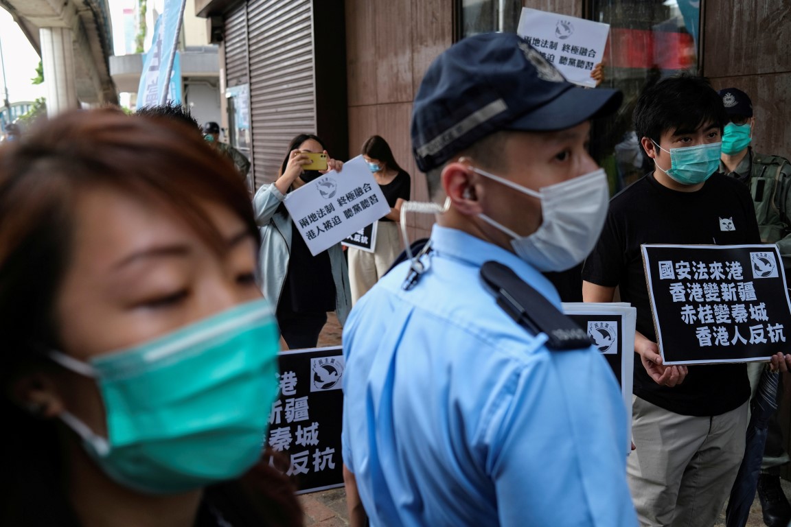 Activists march against new security laws, near China's Liaison Office, in Hong Kong. Photo: Reuters