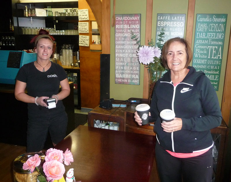 Sticking to contactless takeaway rules are Nosh staff member Kelsey Greer (left) and cafe regular...