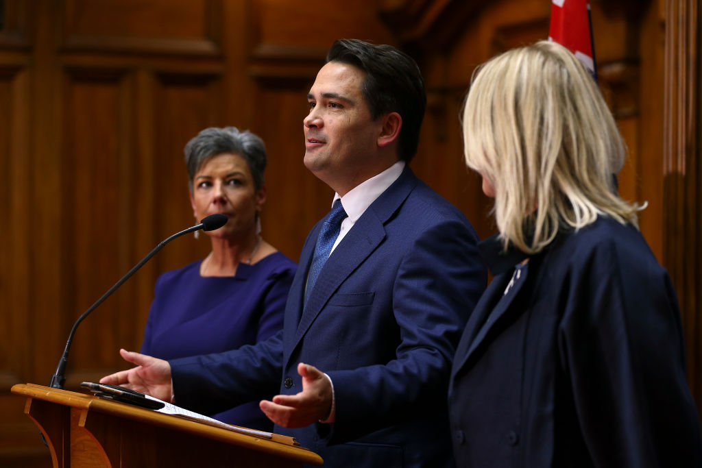 Former National leader Simon Bridges speaks to media while Paula Bennett (L) and wife Natalie...