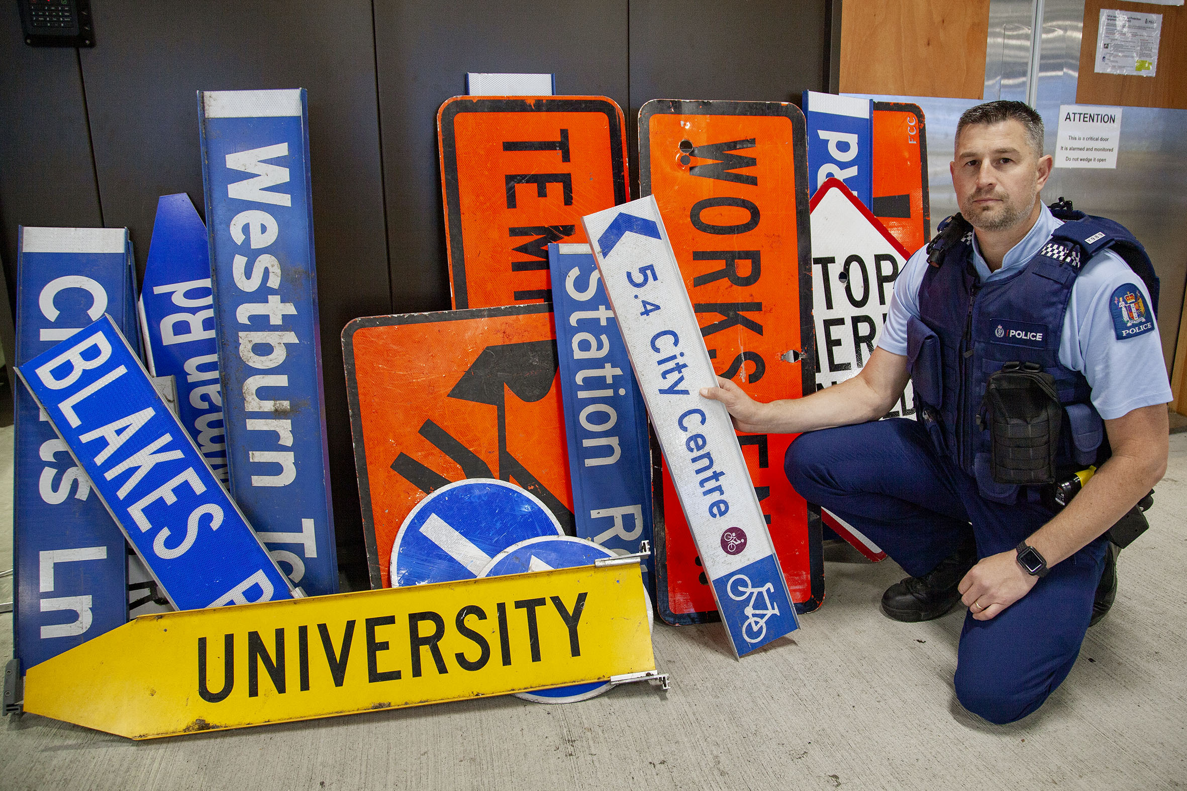 Constable Scott McMurtrie with stolen street signs mostly recovered from student flats around...
