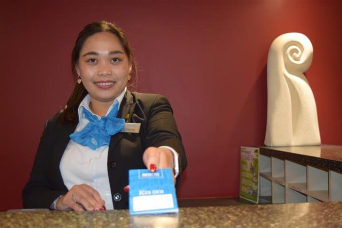 Scenic Hotel Southern Cross senior receptionist Sheena Ragasajo issues a room key in central...