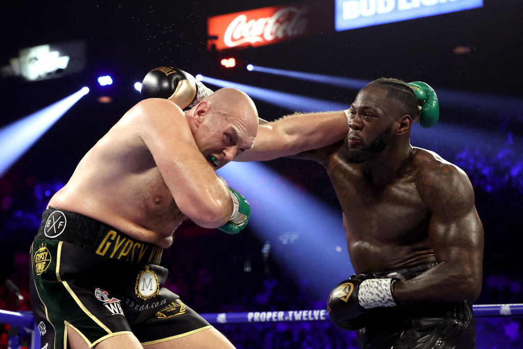 Tyson Fury (L) and Deontay Wilder exchange punches during their heavyweight bout in Las Vegas in...