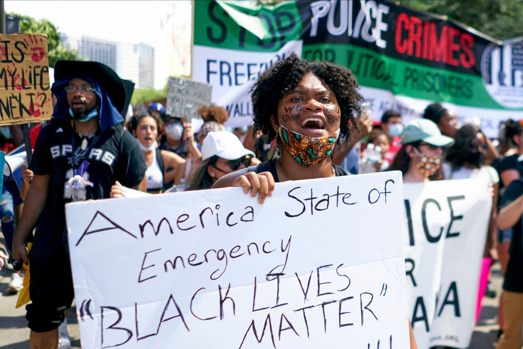 Demonstrators march in Dallas, Texas during a protest against police brutality and racism. Photo:...